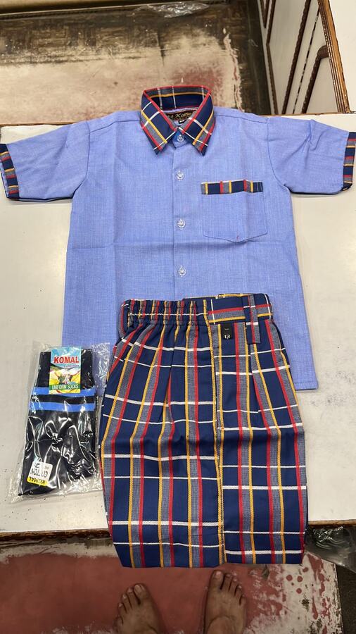 Light blue shirt with checked shorts and socks